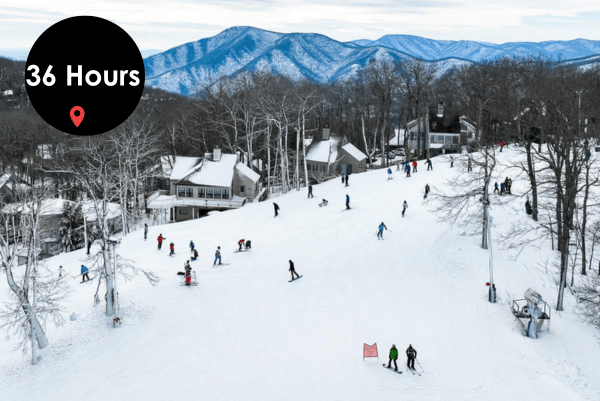 View of people skiing and snowboarding down a snow-covered slope at a ski resort, with mountains in the background and a '36 Hours' logo overlay at the top.