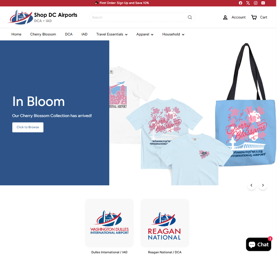 This image displays a promotional webpage for "Shop DC Airports," featuring their Cherry Blossom Collection. It includes t-shirts and a tote bag with cherry blossom designs and airport logos. At the bottom, logos for Washington Dulles International Airport and Reagan National Airport are shown. There are navigation options at the top for various categories including "Travel Essentials" and "Apparel.
