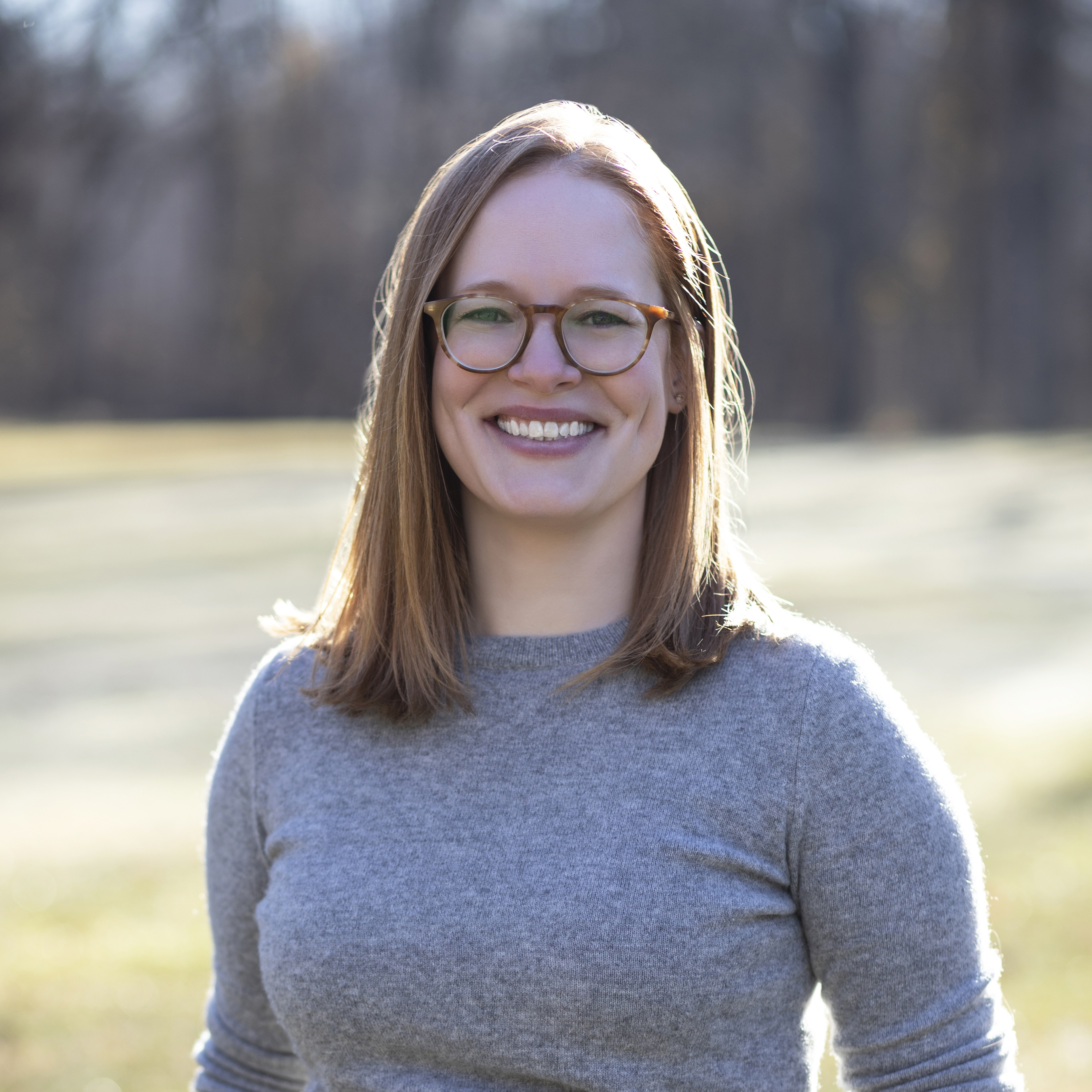 Woman smiling outside.