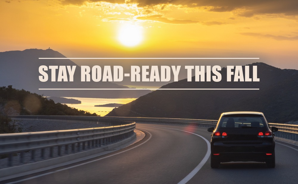 Text “Stay Road-Ready This Fall” over a photo of a car driving n the road into the sunset